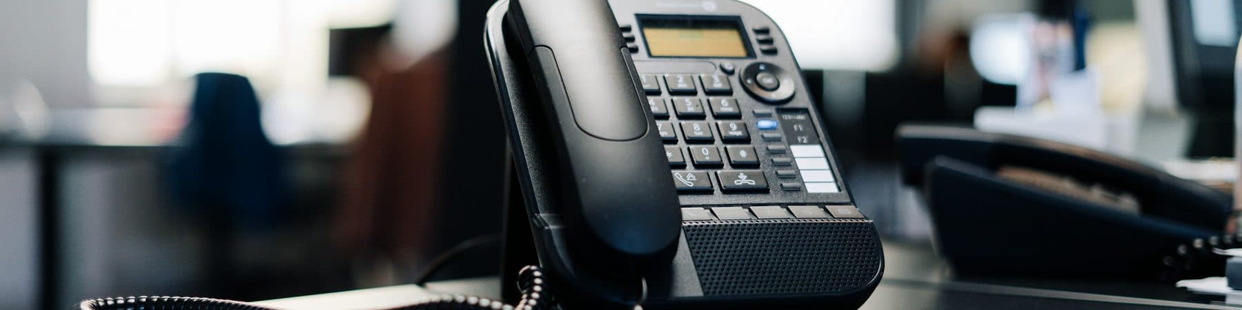 A modern office desk phone, ready to answer a call